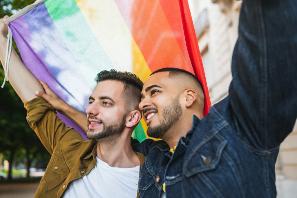 a group of men holding a rainbow flag