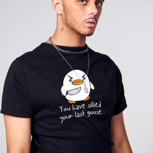 a man wearing a black shirt with a cartoon penguin on it