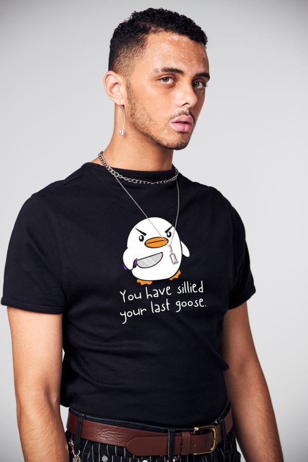 a man wearing a black shirt with a cartoon penguin on it