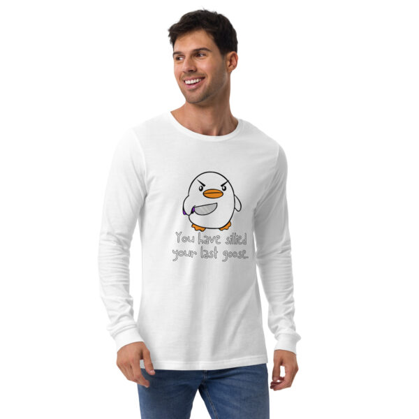 A man wearing a white long-sleeve shirt featuring a cartoon penguin and the text "You Have Sillied Your Last Goose.