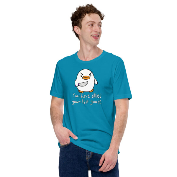 Wearing the "You Have Sillied Your Last Goose" blue t-shirt featuring a cartoon goose, a person stands with one hand in their pocket, looking to the side.