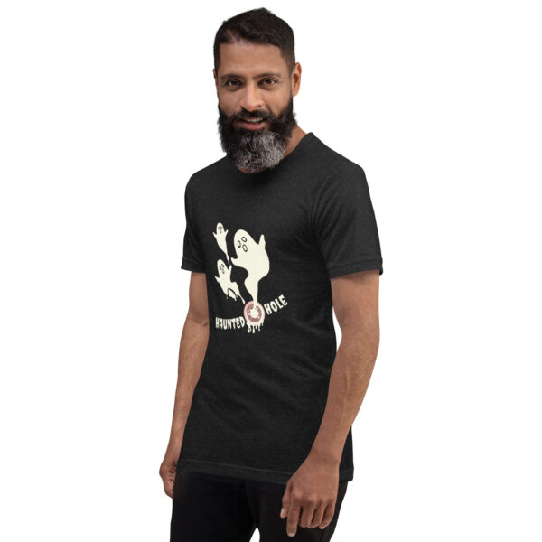 A man with a beard is wearing a black T-shirt featuring cartoon ghosts and the text "Haunted Hole.