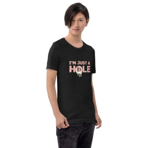 A person is standing and wearing a black T-shirt featuring the "I'm Just a Hole" design in pink and white font.