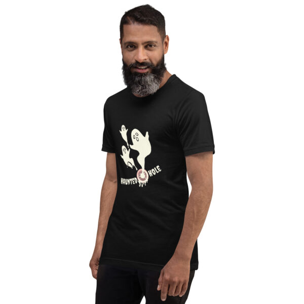 Person wearing a black T-shirt featuring cartoon ghosts and the text "HAUNTED HOLE" printed on it.