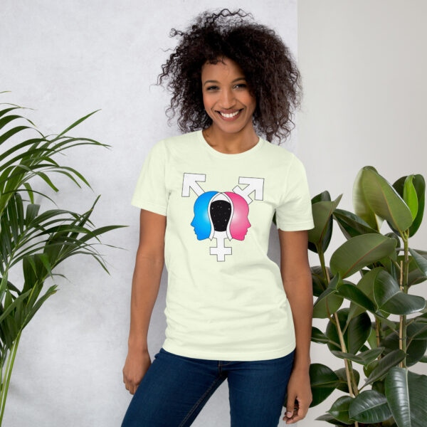 A smiling person wearing the "Beyond the Binary" t-shirt stands by potted plants.