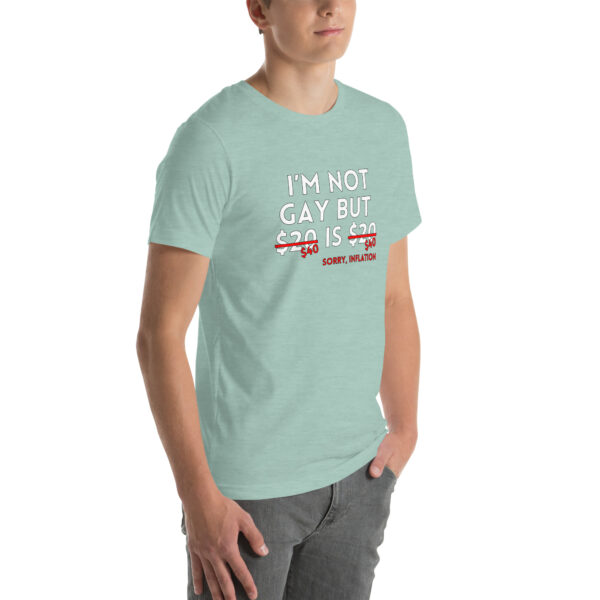 Person wearing a light green T-shirt with text humorously referencing inflation affecting a certain price offer, featuring the product "I'm Not Gay.