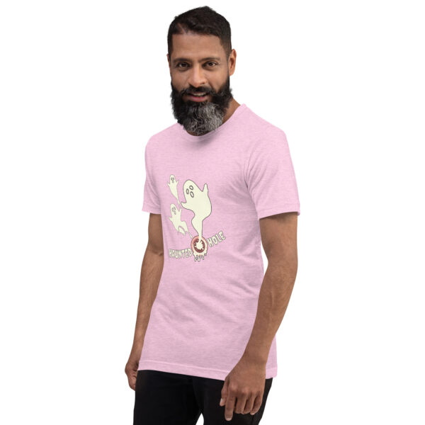 A bearded man wearing a light pink T-shirt with a cartoon ghost and the words "Haunted Hole.