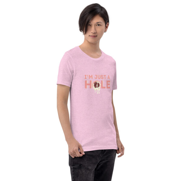 A person wearing the "I'm Just a Hole" T-shirt in light pink stands against a plain background.