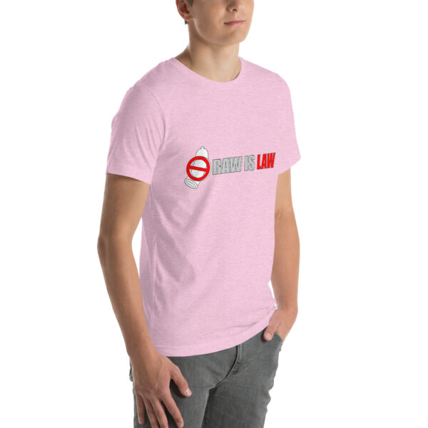 A person wearing a light pink unisex t-shirt featuring a graphic depicting a no-smoking sign along with the phrase "RAW IS LAW" in bold red and gray text.