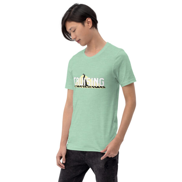 The person is wearing a light green T-shirt named "Cruising," featuring the word "CRUISING" and a graphic of a car, while looking downwards.