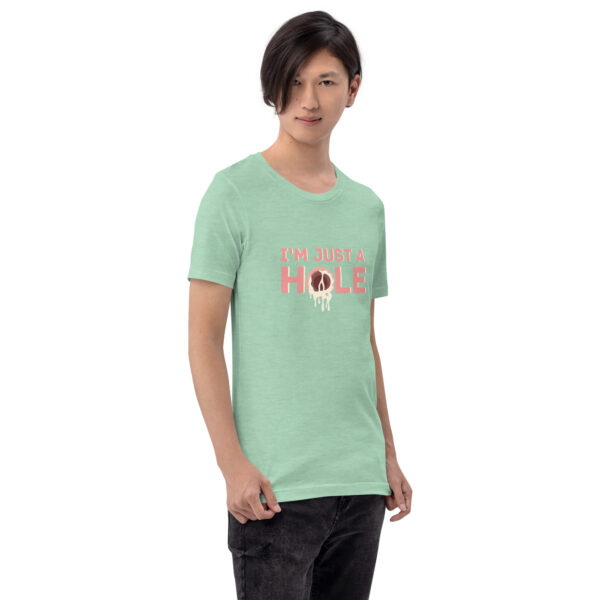 A person wearing a "I'm Just a Hole" green shirt is standing against a plain background.