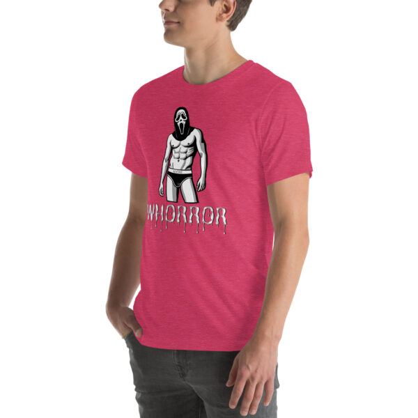 A person wearing a Whorror pink t-shirt featuring an illustration of a masked figure in swimwear and the word "WHORROR.