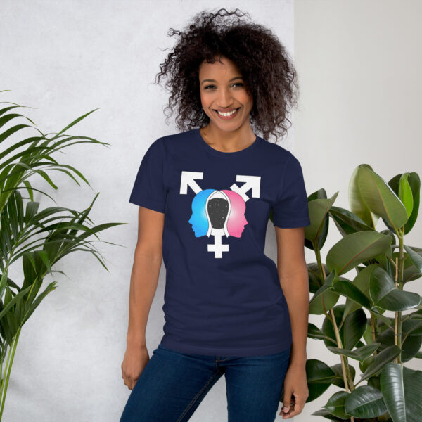 A smiling person wearing the "Beyond the Binary" navy shirt featuring gender symbols and profiles stands beside two potted plants.