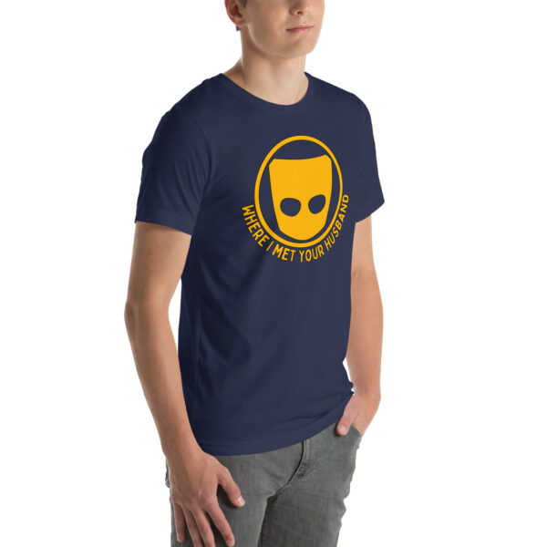 A man wearing a navy blue shirt featuring the product design "Where I Met Your Husband," complete with a yellow mask logo.