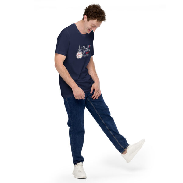 Person in a "Really?! I washed my balls for this!" navy graphic T-shirt and jeans, looking down while lifting one leg slightly, on a plain white background.