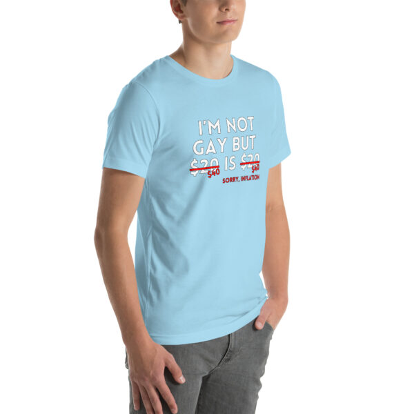 A person wearing a light blue "I'm Not Gay" t-shirt with "$20 is $20" crossed out and replaced with "Sorry, inflation.