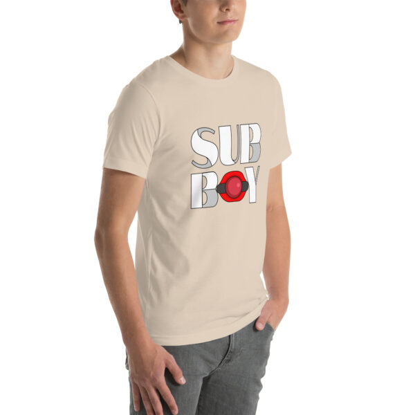 Person wearing a beige T-shirt named "Sub Boy," which showcases a red circular design on the front.