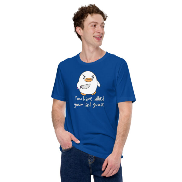 A person is smiling and looking to the side while wearing a blue "You Have Sillied Your Last Goose" t-shirt featuring a cartoon goose.