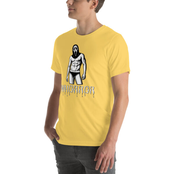 A person wearing a yellow Whorror t-shirt with a graphic of a masked figure in trunks and dripping text below.