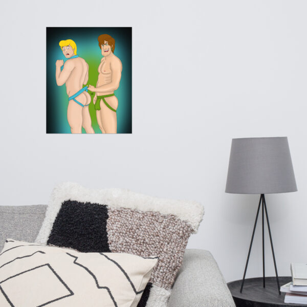 A framed illustration titled "Shaggy and Fred," which features two cartoon men in minimal clothing, is displayed on the wall above a lamp and a sofa adorned with geometric pillows.