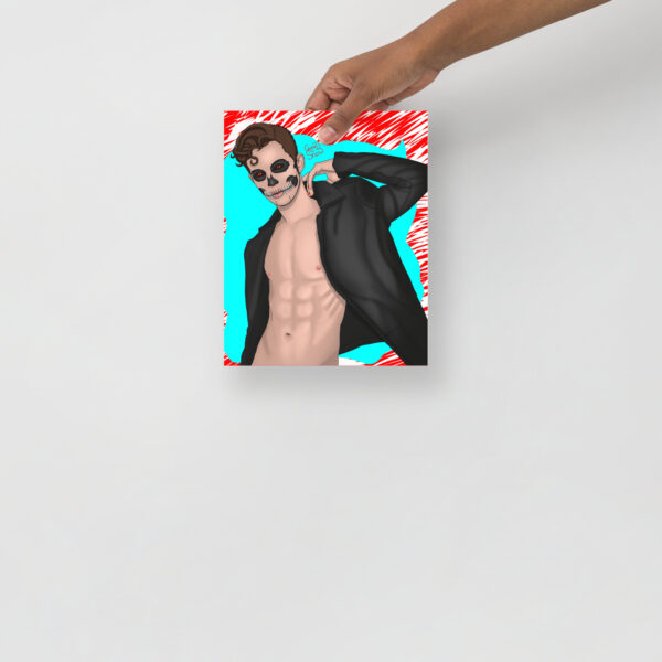 A hand holds a drawing of SkullFace, depicting a shirtless, muscular male figure with a skull face, wearing an open black jacket on a blue and red background.