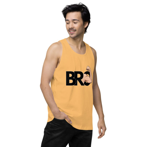 A man wearing a Bro Tank, a sleeveless yellow shirt featuring the word "BRO" and an illustration of an arm flexing.