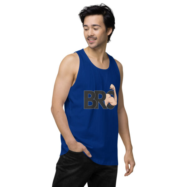 A person in a blue "Bro Tank" featuring a flexed bicep design is smiling with one hand in their pocket.