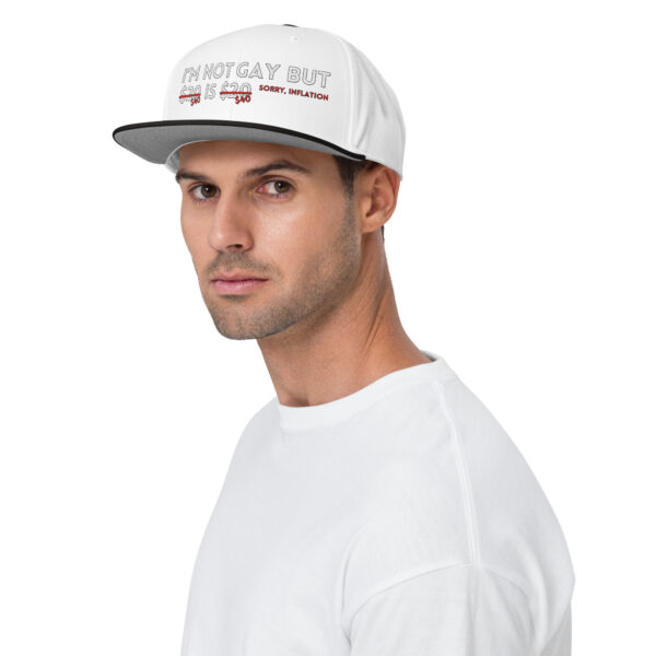 A man wearing the "I'm Not Gay Snapback Hat" and a white shirt, looking toward the camera.