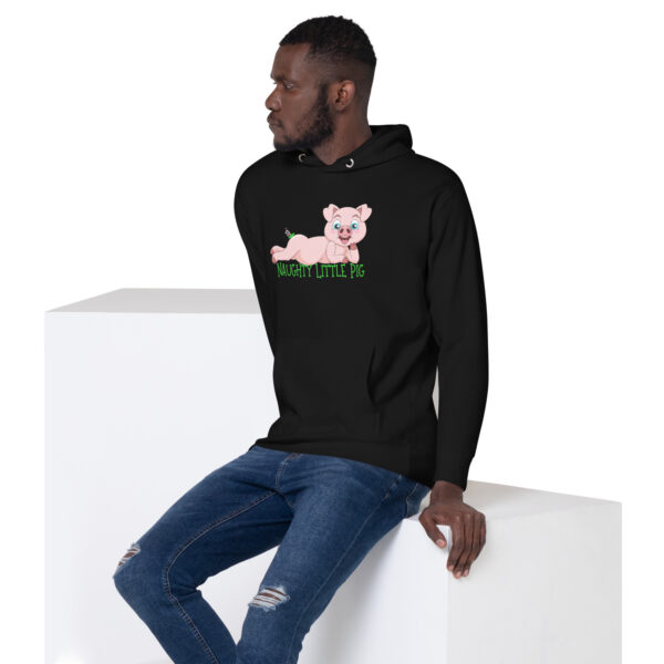 A person sits on a white block wearing the Naughty Little Pig Hoodie, which features a cartoon pig and the words "Naughty Little Pig," paired with blue jeans.