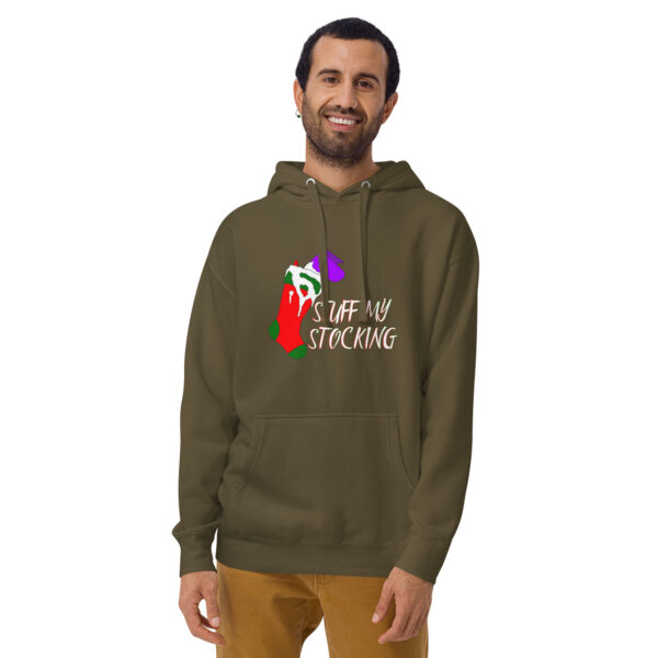 A person wearing a Unisex Hoodie in olive green with a holiday-themed print and message stands against a white background.