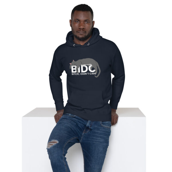 A person wearing a "BIDC Hoodie" featuring the phrase "Bitch, I Don't Care" sits on a white cube against a plain background.