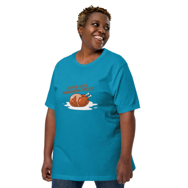 A person wearing a blue T-shirt featuring an illustration of a turkey and the text "Stuff Me.