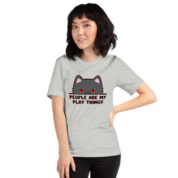 A person wearing the "People Are My Play Things" gray T-shirt featuring a cat illustration.