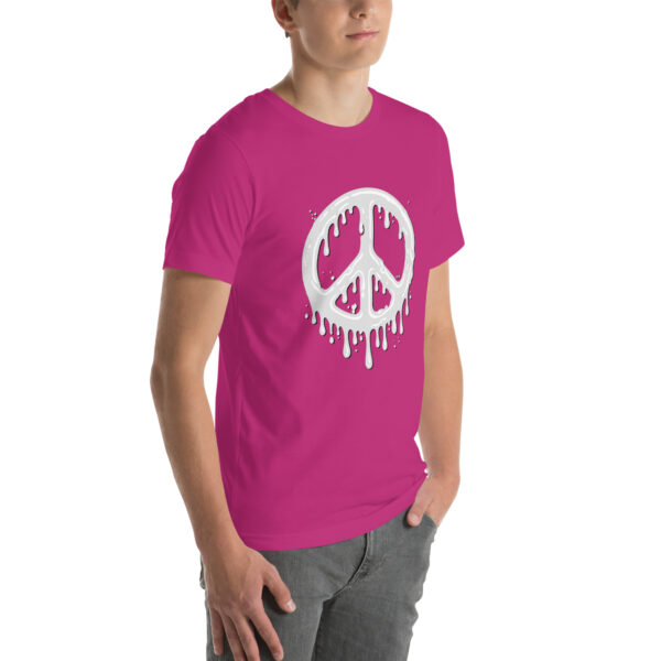 Person wearing the "Cum in Peace" hot pink t-shirt featuring a white drippy peace symbol, paired with gray pants.