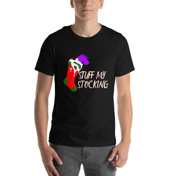 A person sporting a black T-shirt featuring a vibrant stocking illustration and the words "Stuff My Stocking.