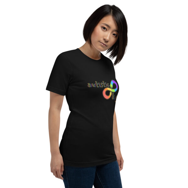 A person wearing a black t-shirt from the "Autistic & Gay" collection, featuring a colorful infinity symbol and the word "autistic.