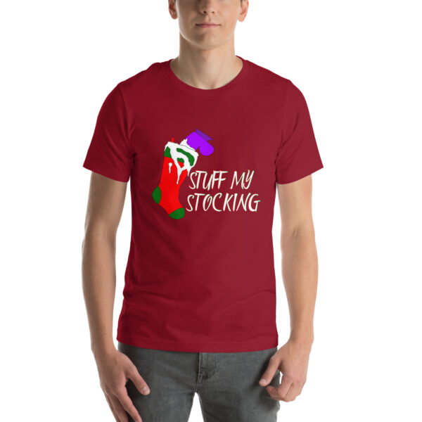 A person wearing a red t-shirt featuring the "Stuff My Stocking" design, with a graphic of a stocking filled with gifts and the accompanying text.