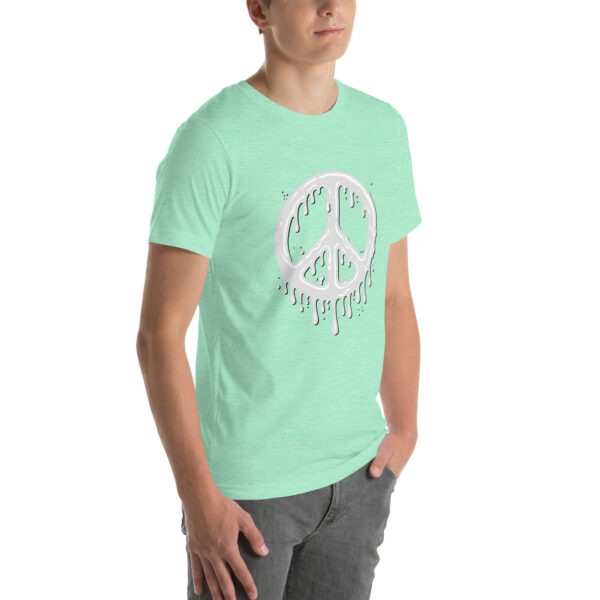 A person wearing the "Cum in Peace" t-shirt, which features a mint green color and a dripping white peace symbol graphic.