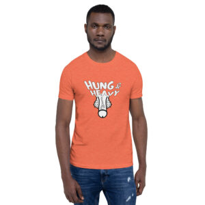 A man wearing the "Hung and Heavy" orange T-shirt, featuring a graphic, stands against a plain background.