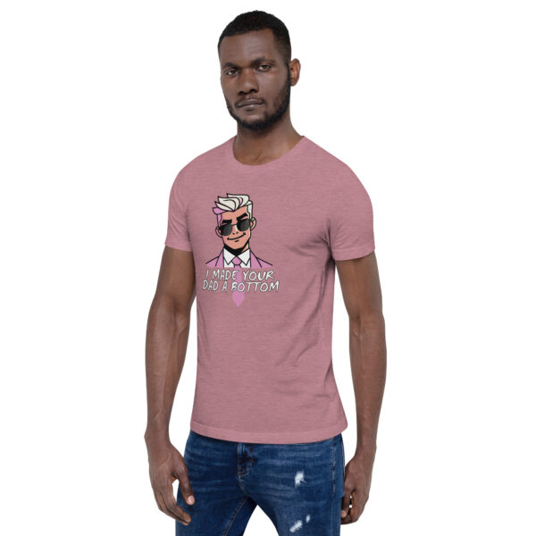 A man in a quirky pink T-shirt featuring the product name "I Made Your Dad A Bottom" displays a cartoon character.