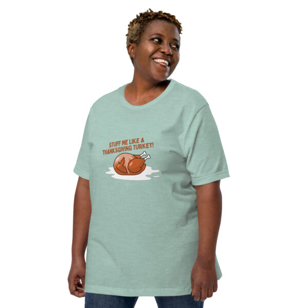 A person in a green T-shirt featuring a cartoon turkey and the phrase "STUFF ME LIKE A THANKSGIVING TURKEY!" from the Stuff Me collection.