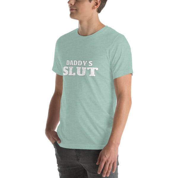 A person wearing a light green shirt featuring the product name "Daddy's Slut" prominently printed in bold white letters.