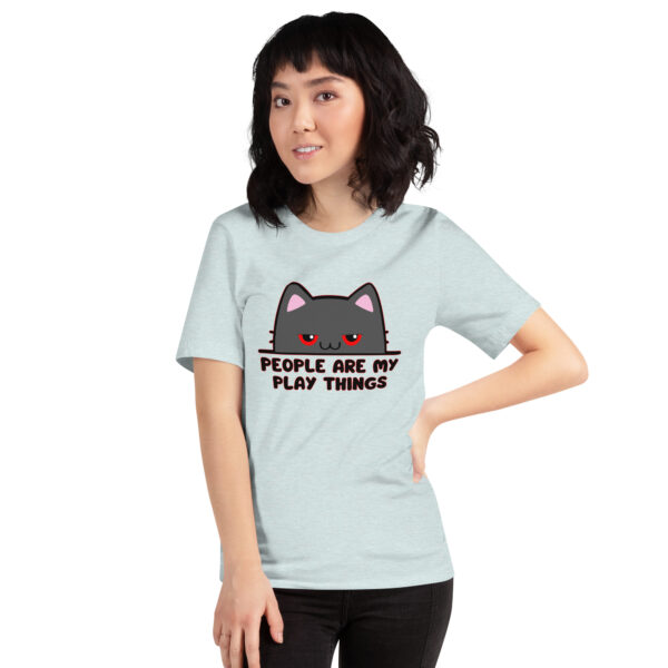 A person wearing a light blue t-shirt featuring a cartoon cat and the product name "People Are My Play Things.