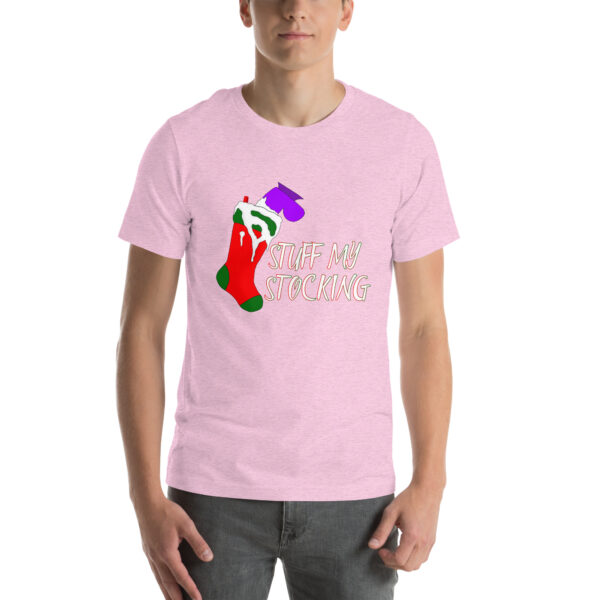 Man wearing a light pink "Stuff My Stocking" T-shirt with a design showcasing a green and red Christmas stocking and the text "STUFF MY STOCKING" in white.