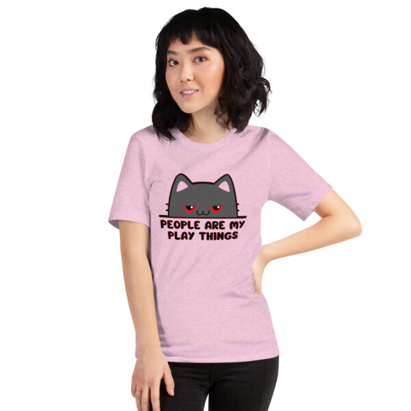 A person wearing a pink t-shirt with a cartoon cat and the "People Are My Play Things" design.