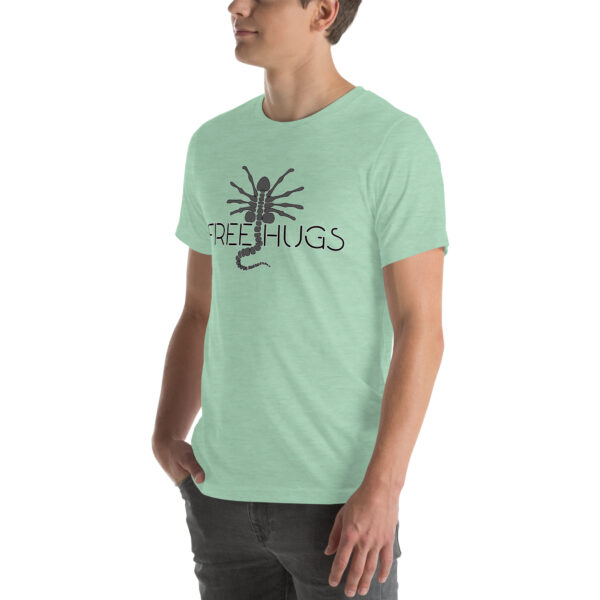 Person wearing a "Free Hugs" light green T-shirt featuring a black scorpion graphic.