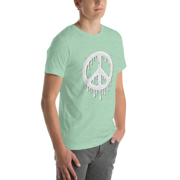 The person is wearing the "Cum in Peace" mint green T-shirt featuring a dripping peace sign design, paired with gray pants.