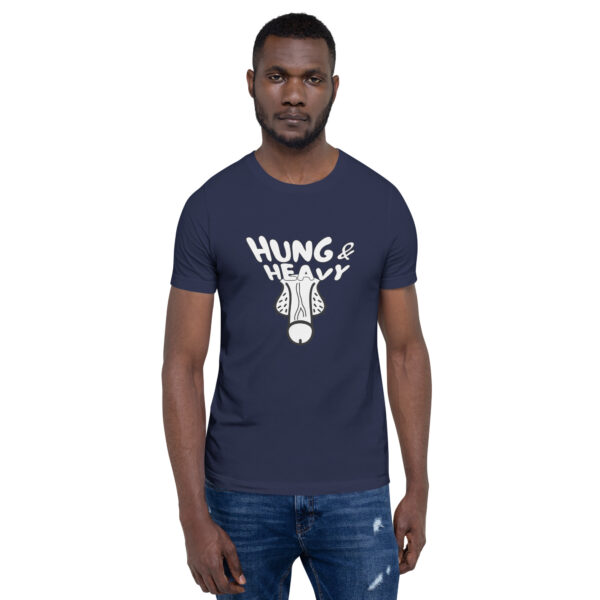 A man wears a navy t-shirt featuring the product name "Hung and Heavy" along with an illustration of a dog's face.