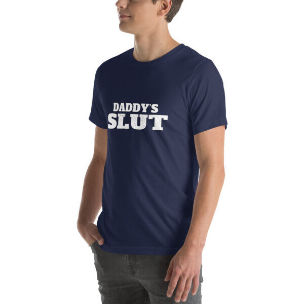 An individual is modeling a blue t-shirt that features the product name "Daddy's Slut" in white text, set against a plain backdrop.