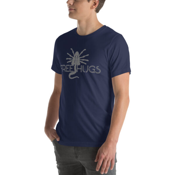 A person wearing a "Free Hugs" t-shirt in navy blue featuring a facehugger graphic.